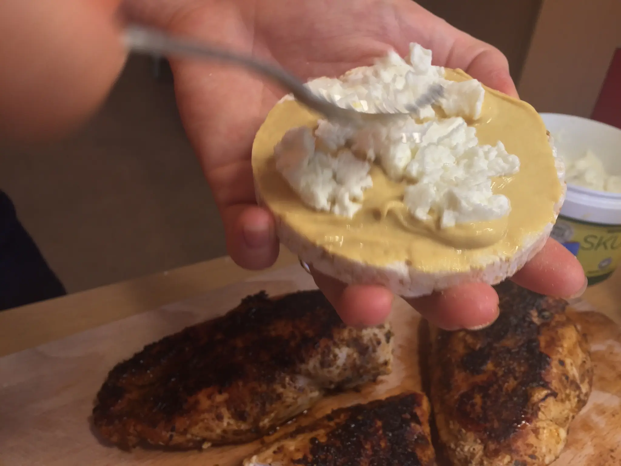 Cottage cheese going onto the mustard rice cake